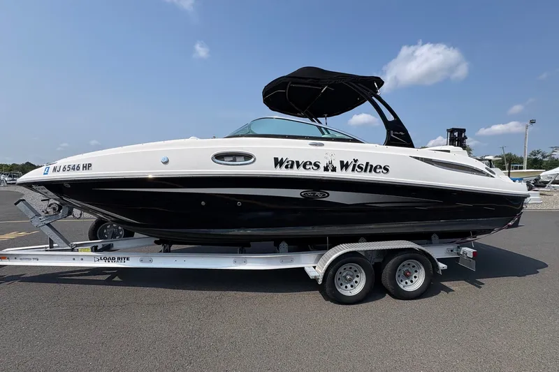 Slide: The Image of 2014 Sea Ray 260 Sundeck boat on trailer, labeled "Waves Wishes," under clear blue sky. - 5