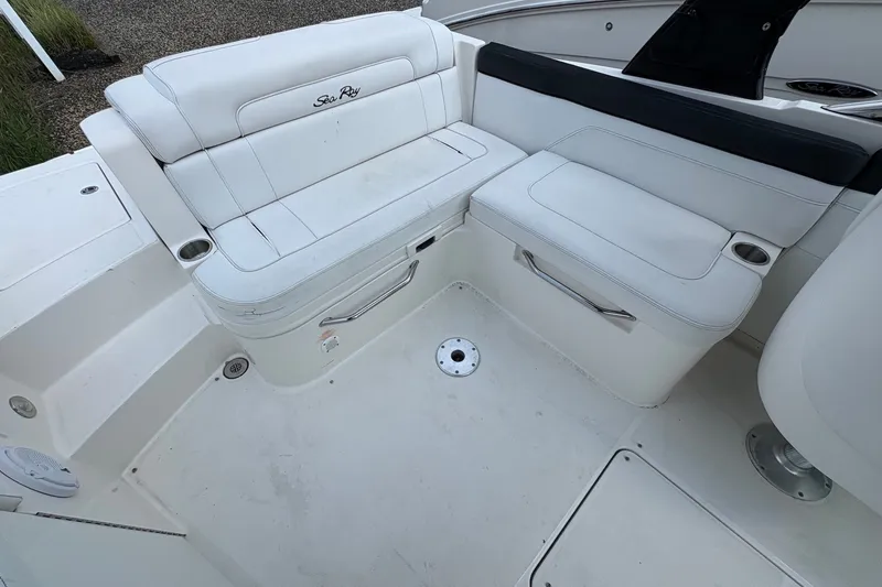 Slide: The Image of 2014 Sea Ray 260 Sundeck interior with white seating and cup holders. - 12