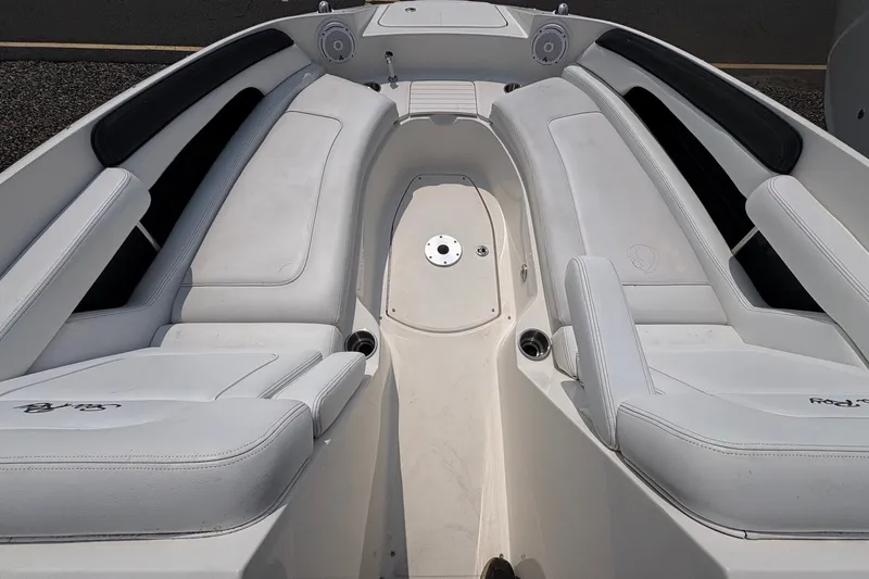 Slide: The Image of 2014 Sea Ray 260 Sundeck interior with white seating and cup holders. - 14