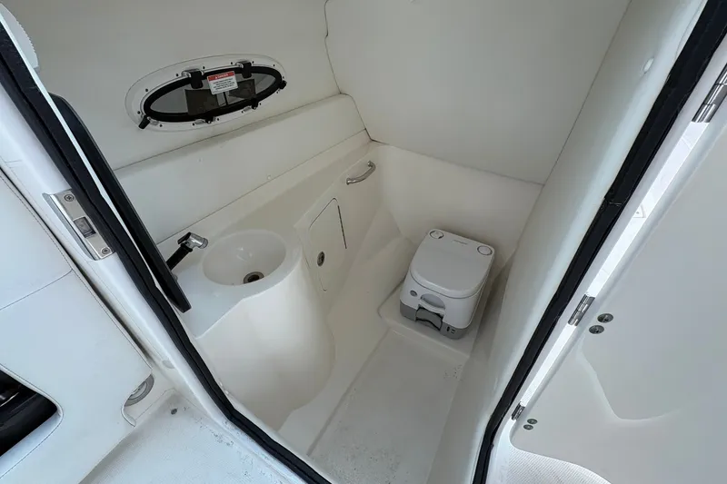 Slide: The Image of 2014 Sea Ray 260 Sundeck boat bathroom with sink and portable toilet. - 15
