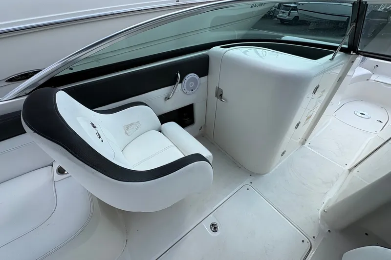 Slide: The Image of 2014 Sea Ray 260 Sundeck interior with white seating and sleek dashboard design. - 9