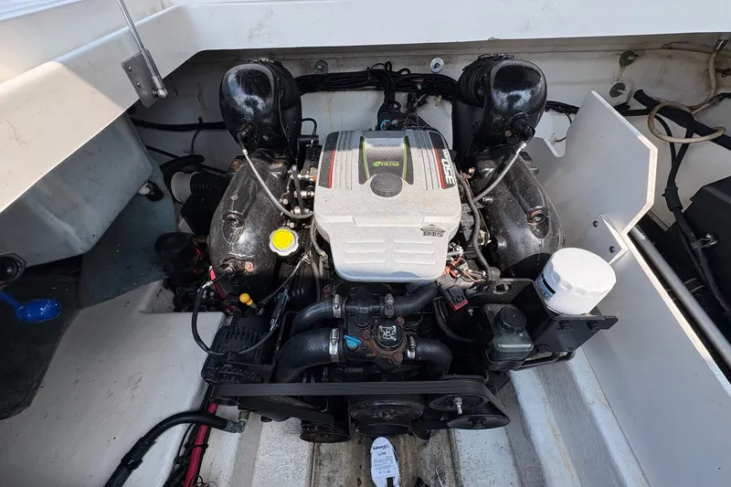 Slide: The Image of Engine compartment of a 2014 Sea Ray 260 Sundeck boat, showcasing the engine components. - 16