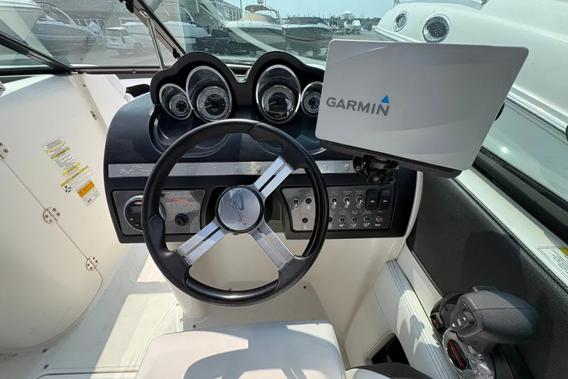 Slide: The Image of 2014 Sea Ray 260 Sundeck dashboard with Garmin navigation system and steering wheel. - 8
