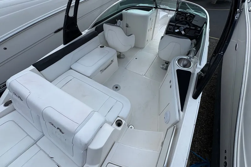 Slide: The Image of 2014 Sea Ray 260 Sundeck interior with white seating and modern dashboard. - 7