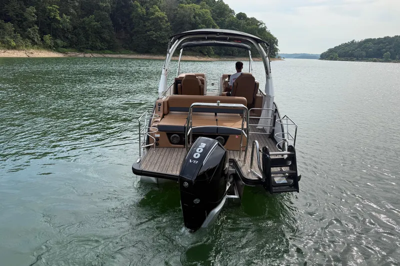 Slide: The Image of 2026 Harris Grand Mariner 230 SLDH cruising on a serene lake with lush forest backdrop. - 4