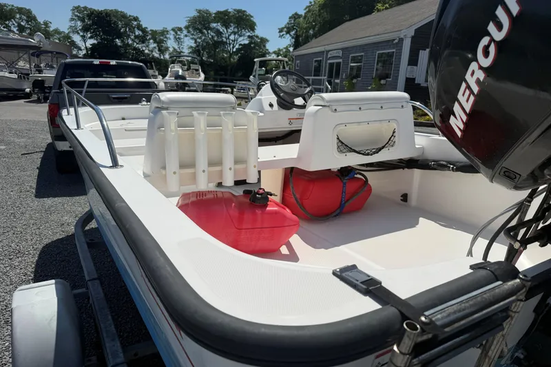 Slide: The Image of 2008 Boston Whaler 150 Sport boat with Mercury engine, parked on a trailer. - 7