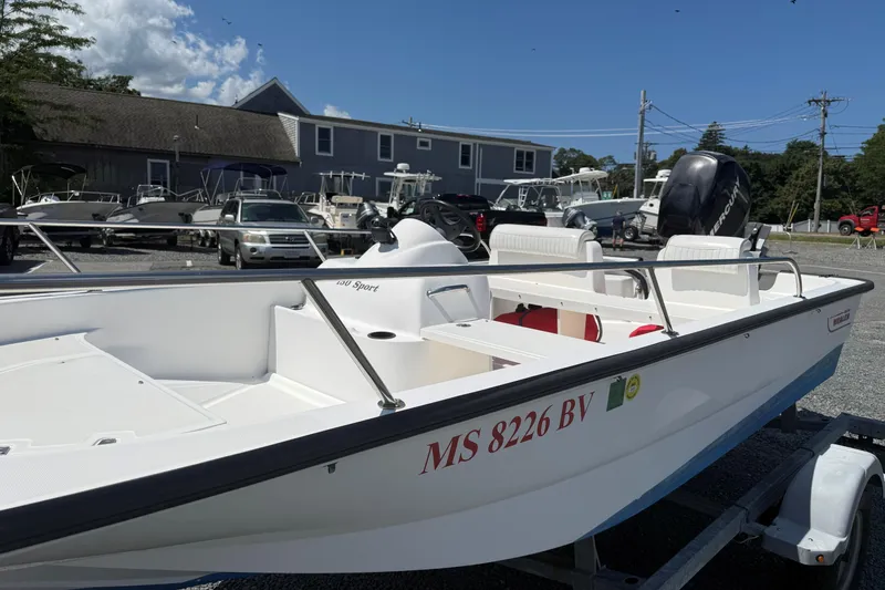 Slide: The Image of 2008 Boston Whaler 150 Sport boat on trailer in marina parking lot. - 9
