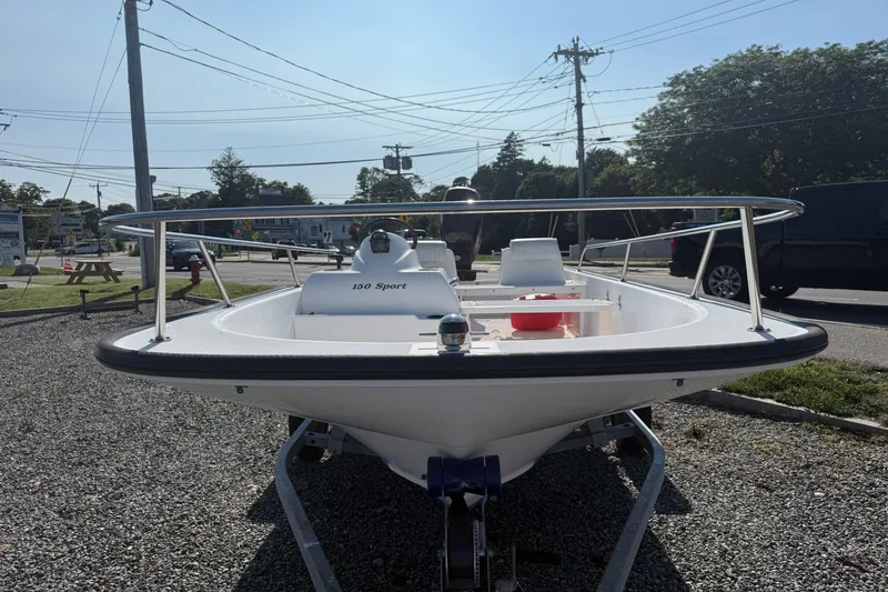 Slide: The Image of 2008 Boston Whaler 150 Sport boat on trailer in outdoor setting. - 2