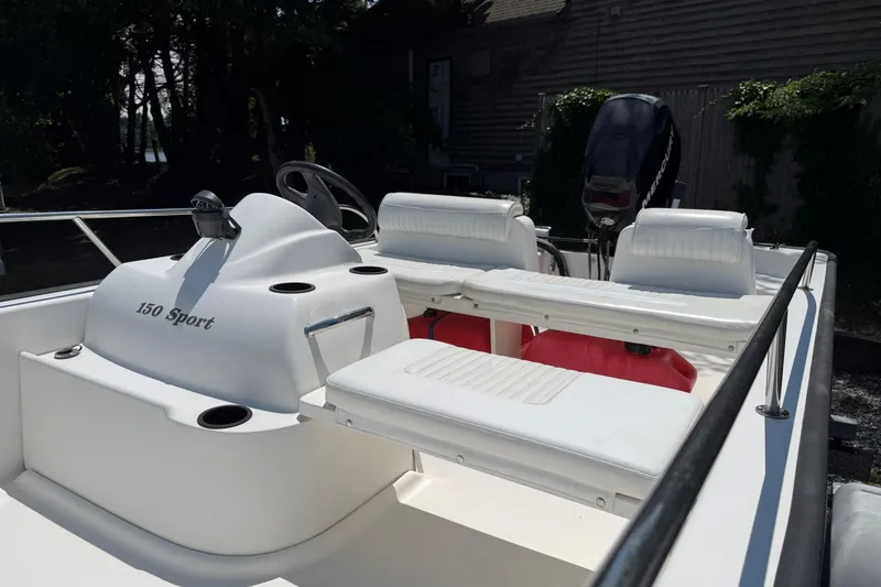 Slide: The Image of 2008 Boston Whaler 150 Sport boat interior with seating and steering console. - 8