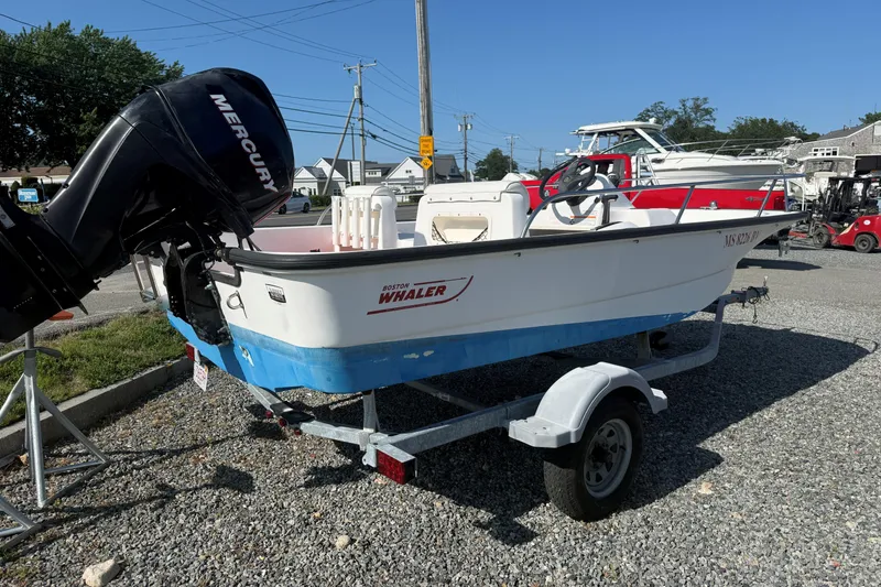 Slide: The Image of 2008 Boston Whaler 150 Sport boat on trailer with Mercury outboard motor. - 4