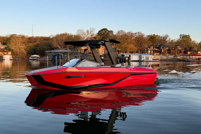 The Image of 2025 Nautique Super Air Nautique G23 boat on calm lake at sunset. - 0
