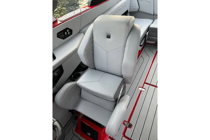 Slide: The Image of 2025 Nautique Super Air Nautique G23 interior with sleek gray seating and red accents. - 12
