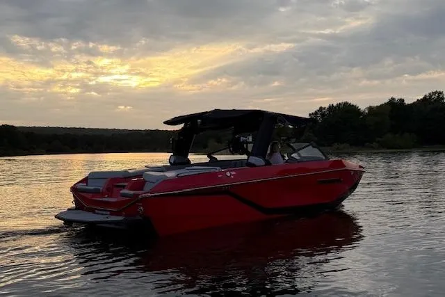 Slide: The Image of 2025 Nautique Super Air Nautique G23 boat on a lake at sunset. - 6