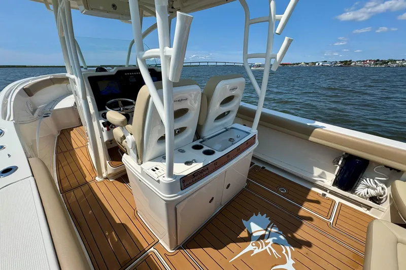 Slide: The Image of 2017 Sailfish 290 CC boat interior with helm, seats, and ocean view. - 19