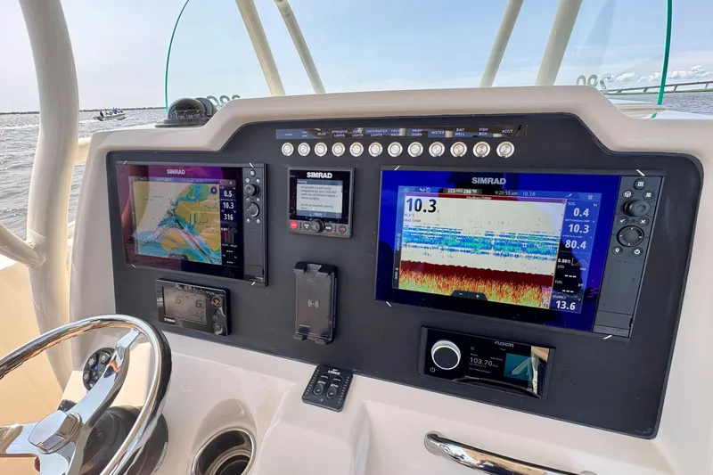 Slide: The Image of Control panel of a 2017 Sailfish 290 CC boat with Simrad navigation displays. - 13