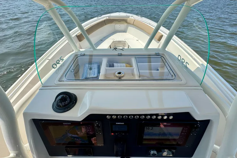 Slide: The Image of 2017 Sailfish 290 CC boat dashboard with navigation equipment on open water. - 16