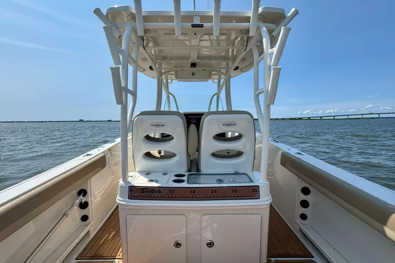 Slide: The Image of 2017 Sailfish 290 CC boat on water, featuring dual seats and a center console. - 21