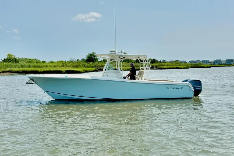The Image of 2017 Sailfish 290 CC boat on calm water, featuring a sleek design and Yamaha engines. - 1