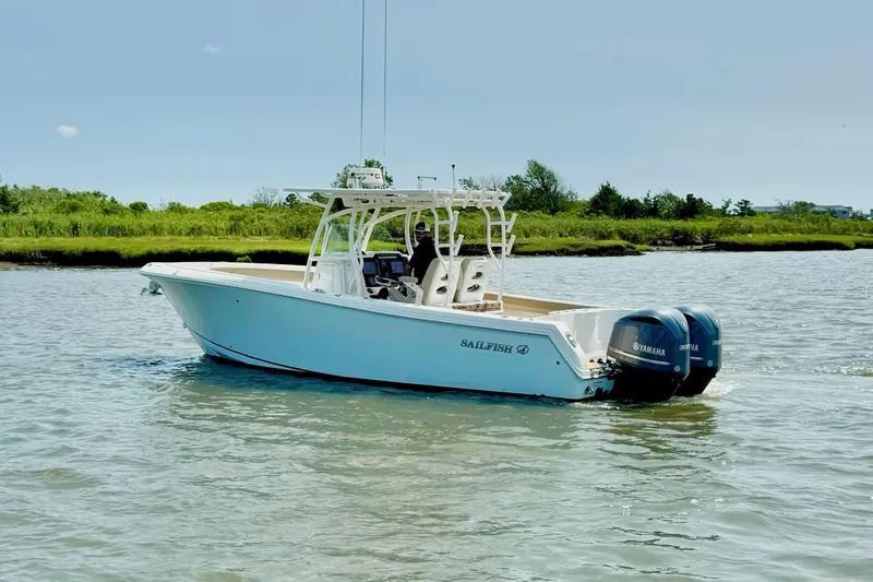 Slide: The Image of 2017 Sailfish 290 CC boat with twin Yamaha engines on calm water. - 4