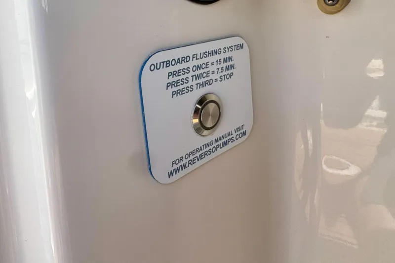 Slide: The Image of Outboard flushing system button on 2017 Sailfish 290 CC boat. - 27