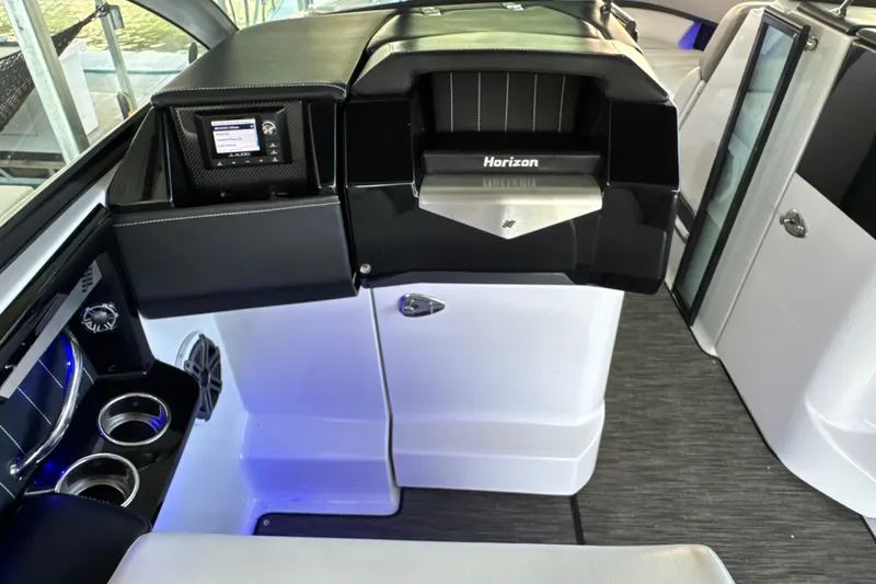 Slide: The Image of Interior of 2017 Four Winns H290 boat with modern dashboard and cup holders. - 12