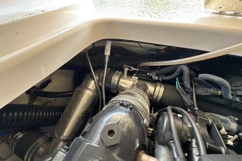 Slide: The Image of Engine compartment of a 2017 Four Winns H290 boat, showcasing hoses and components. - 39