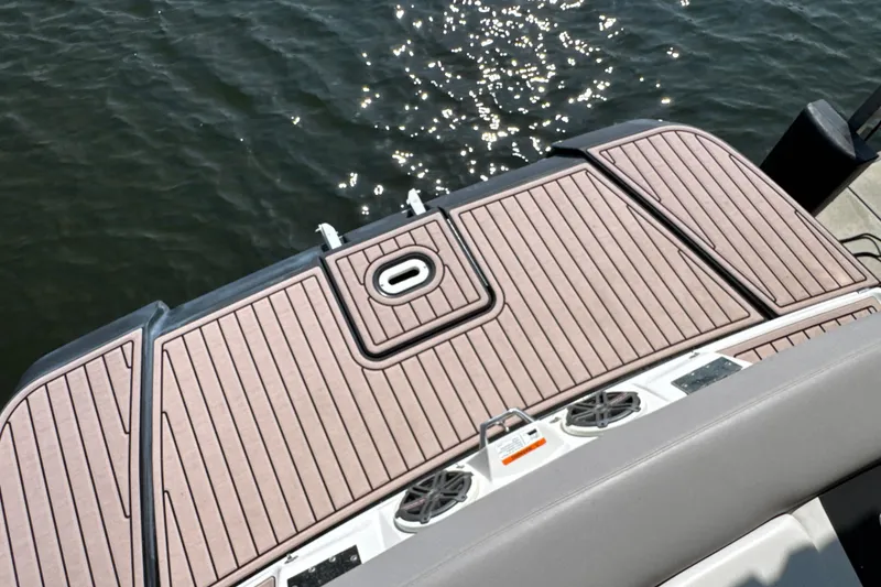 Slide: The Image of 2017 Four Winns H290 boat deck with wood finish, overlooking sparkling water. - 33