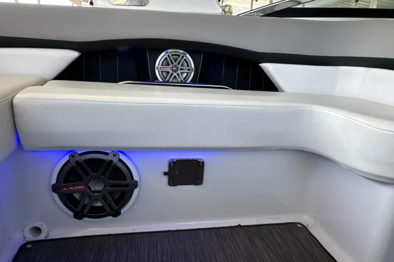 Slide: The Image of Interior of 2017 Four Winns H290 boat featuring JL Audio speakers and white seating. - 26