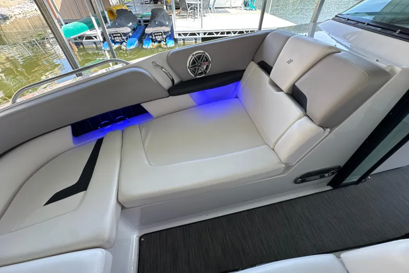 Slide: The Image of Luxurious seating area on 2017 Four Winns H290 boat with blue LED lighting. - 23