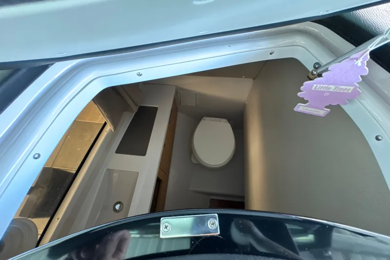 Slide: The Image of Interior view of 2017 Four Winns H290 boat bathroom with toilet and sink. - 29