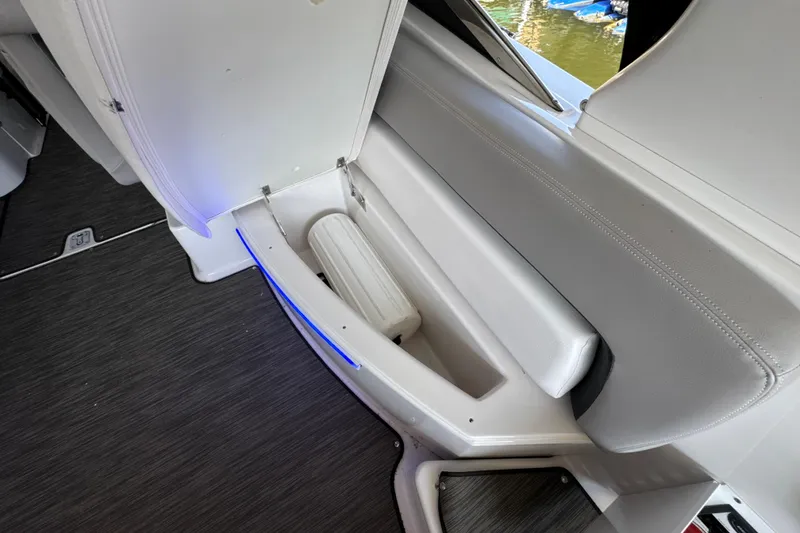 Slide: The Image of Interior view of 2017 Four Winns H290 boat with storage compartment and blue LED lighting. - 51