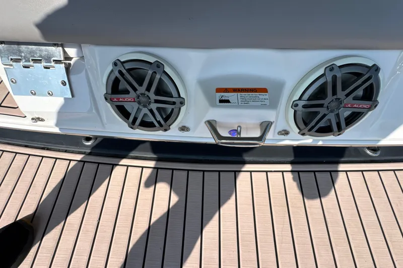 Slide: The Image of 2017 Four Winns H290 boat speakers and warning label on deck. - 34
