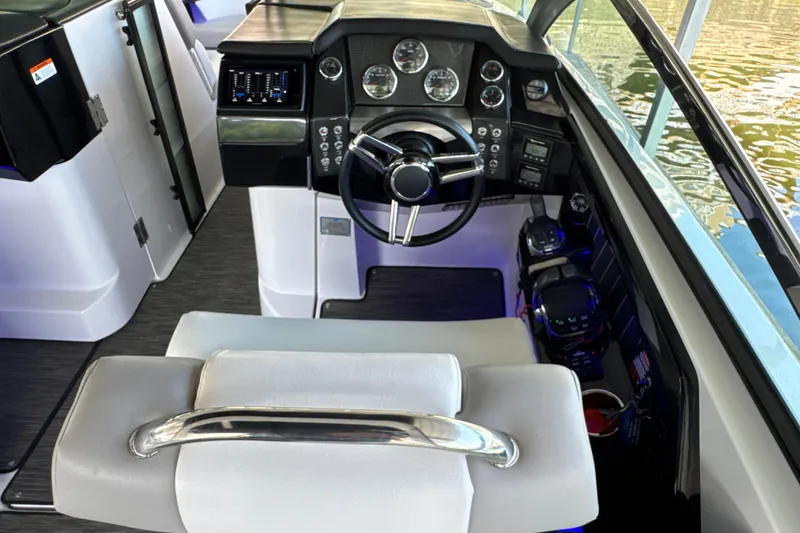 Slide: The Image of Interior view of 2017 Four Winns H290 boat cockpit with modern controls and steering wheel. - 10