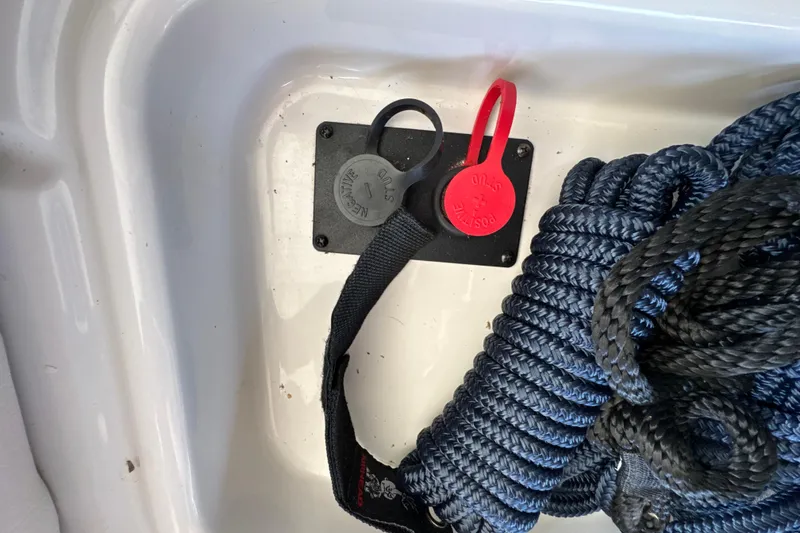 Slide: The Image of Coiled rope and safety switch in 2017 Four Winns H290 boat compartment. - 57