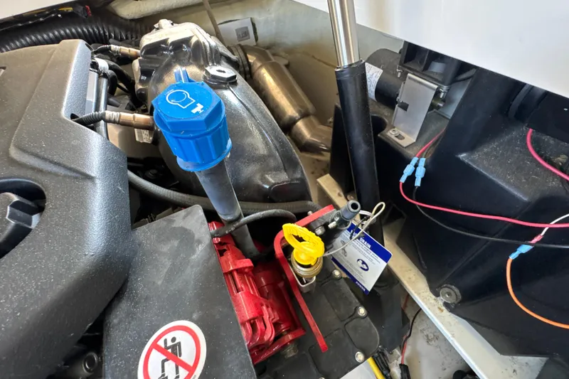 Slide: The Image of Engine compartment of a 2017 Four Winns H290 boat, featuring various components and wiring. - 40