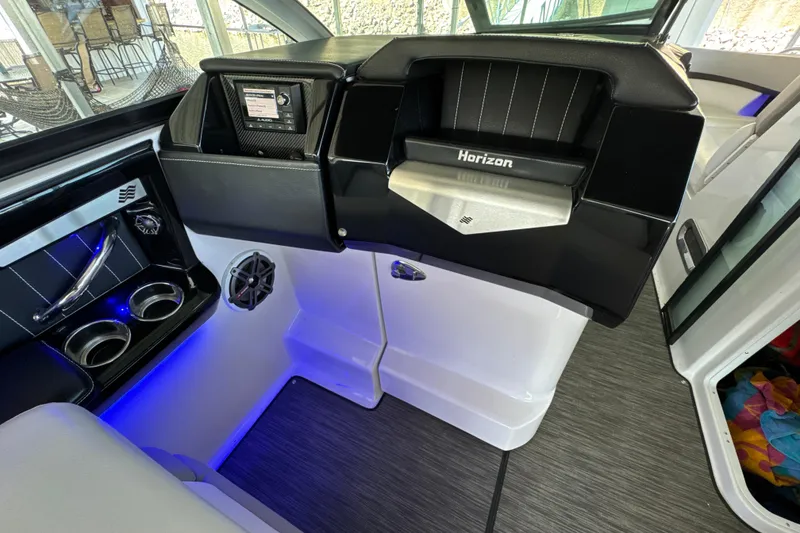 Slide: The Image of Interior of 2017 Four Winns H290 boat with modern dashboard and cup holders. - 13