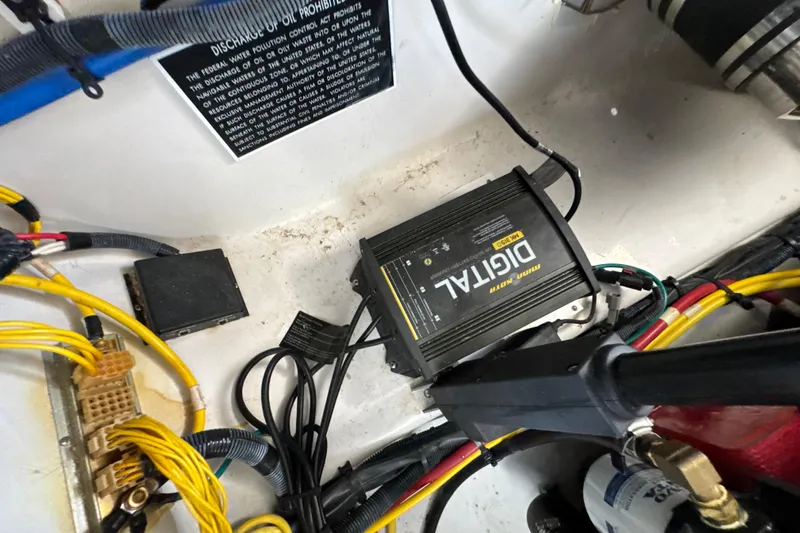 Slide: The Image of Engine compartment of 2017 Four Winns H290 boat with digital charger and wiring. - 41