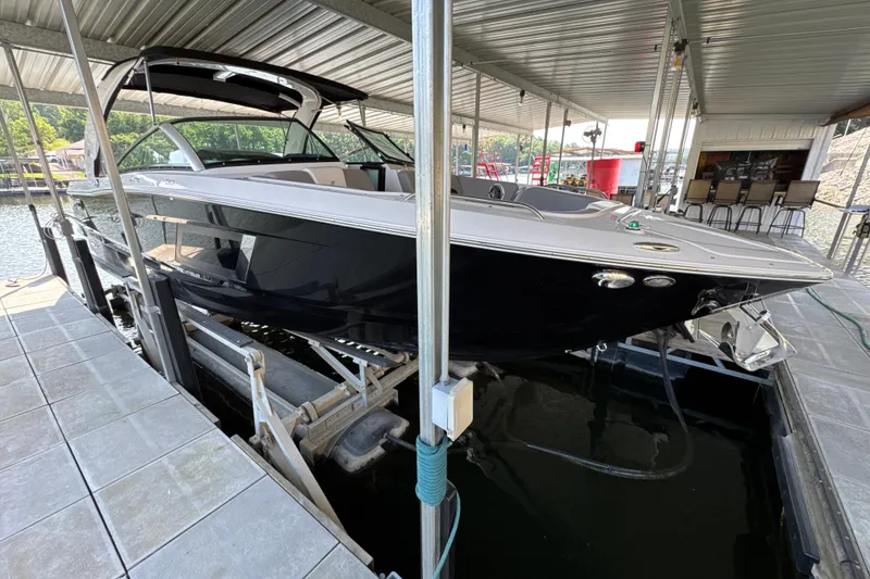 The Image of 2017 Four Winns H290 boat docked under a covered marina. - 0