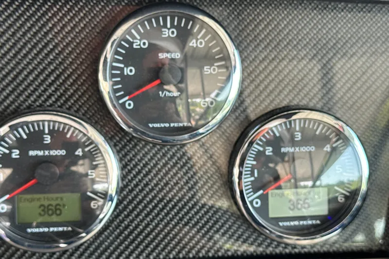 Slide: The Image of Dashboard gauges of a 2017 Four Winns H290 boat, showing speed and RPM. - 45