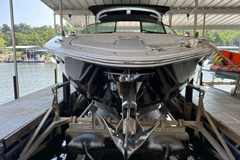 Slide: The Image of 2017 Four Winns H290 boat docked in a covered marina, front view. - 2