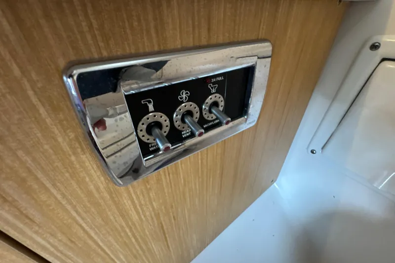 Slide: The Image of Control panel on 2017 Four Winns H290 boat, featuring switches for water and ventilation. - 30