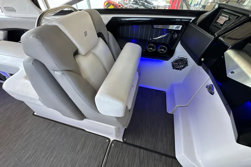 Slide: The Image of The image shows the interior of a 2017 Four Winns H290 boat with gray and white seating. - 11