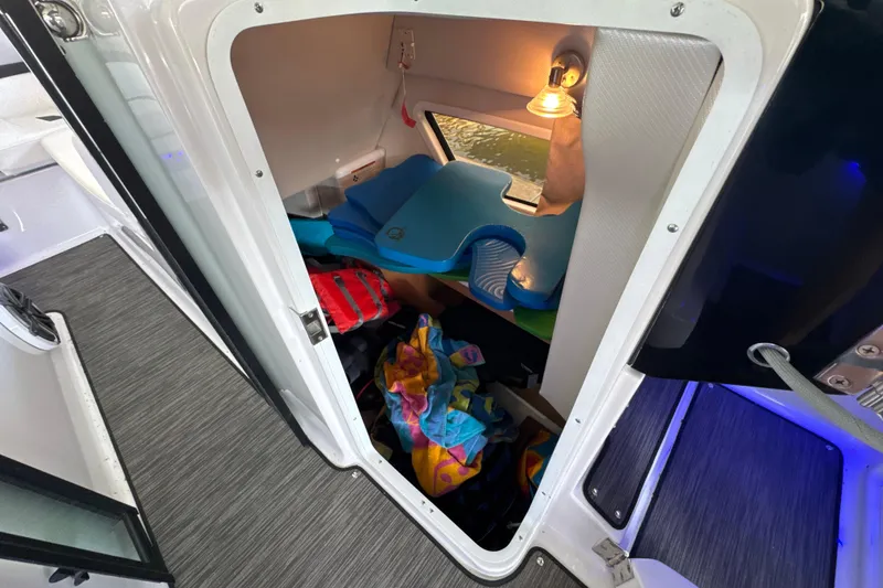Slide: The Image of Cozy cabin interior of 2017 Four Winns H290 boat with storage and lighting. - 55