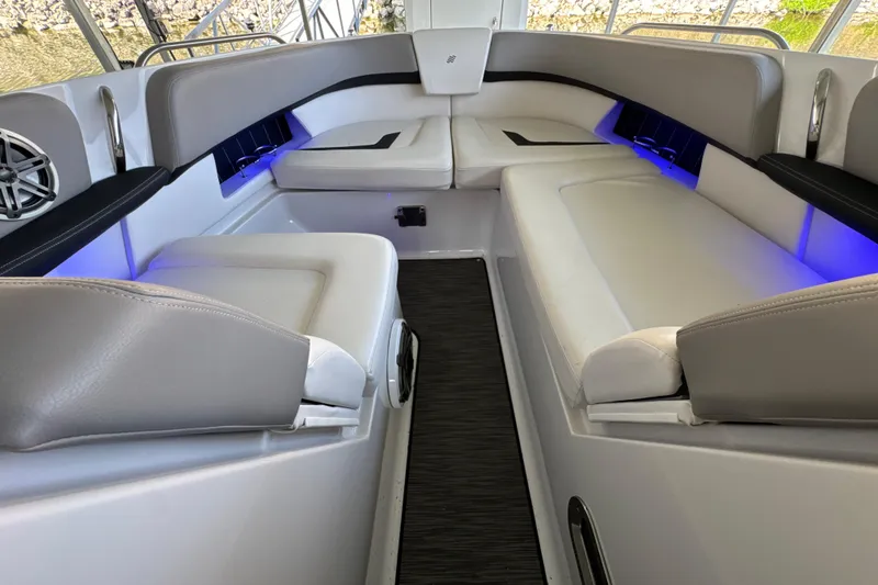 Slide: The Image of Interior of 2017 Four Winns H290 boat with sleek seating and ambient lighting. - 22