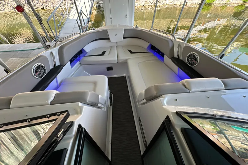 Slide: The Image of Luxurious 2017 Four Winns H290 boat interior with plush seating and ambient lighting. - 20