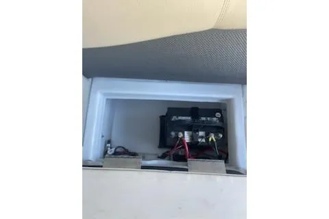 Slide: The Image of 2023 PlayCraft 27 Infinity boat battery compartment with visible wiring. - 7