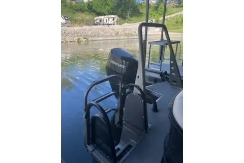 Slide: The Image of 2023 PlayCraft 27 Infinity boat with motor, docked on a calm lake. - 5