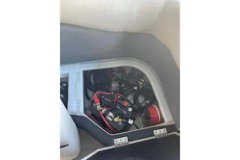 Slide: The Image of 2023 PlayCraft 27 Infinity boat battery compartment with wiring and components. - 6