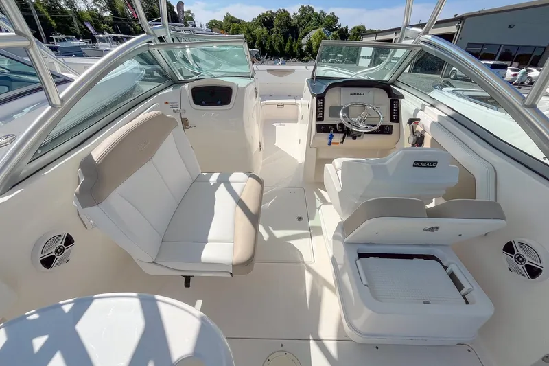 Slide: The Image of 2019 Robalo R247 Dual Console boat interior with seating and steering console. - 9