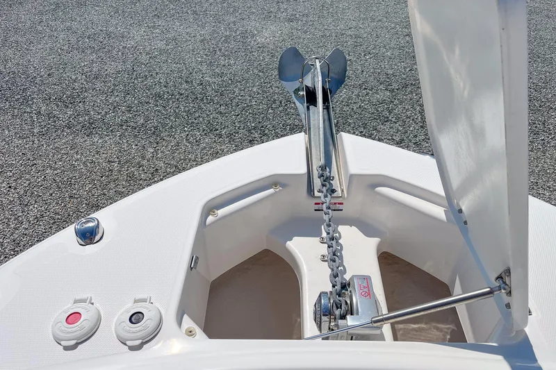 Slide: The Image of 2019 Robalo R247 Dual Console boat anchor compartment with chain and hatch open. - 14
